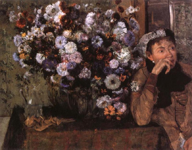  A Woman seated beside a vase of flowers
